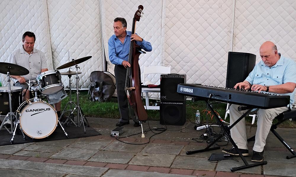 The Joe Carozza Trio performed a variety of jazz standards at the June 25 fundraiser at Buttermilk Falls, with Carozza on drums, Jim Curtin on vocals and upright bass and Peter Tomlinson on piano.